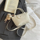 Silvery Compact PU Leather Crossbody Bag With a pendant- Lightweight Handheld Shoulder Purse with Adjustable Strap, Zipper Closure and Metal Feet for Women, Daily Commute and Travel